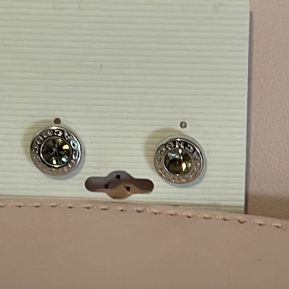 Coach stud earrings with a gray stone